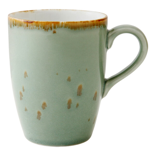 A Erthe by Fortessa Celadon mug with brown speckles.
