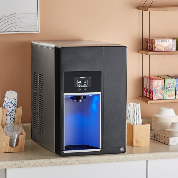 A black rectangular Follett countertop ice and water machine with a blue light on the front.