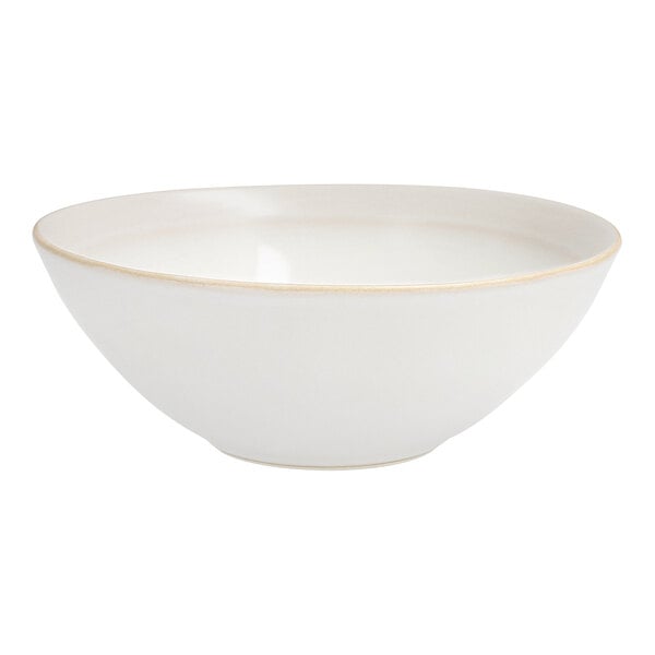 A Nosse by Fortessa ivory stoneware bowl with a gold rim.