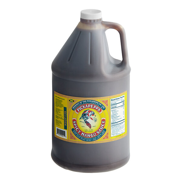 A grey jug of Pickapeppa Spicy Mango Sauce with a yellow label and lid.