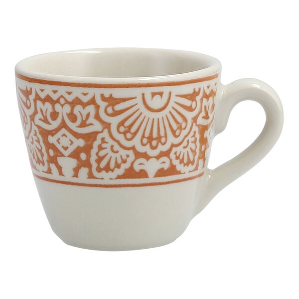 A white espresso cup with an orange design on it.