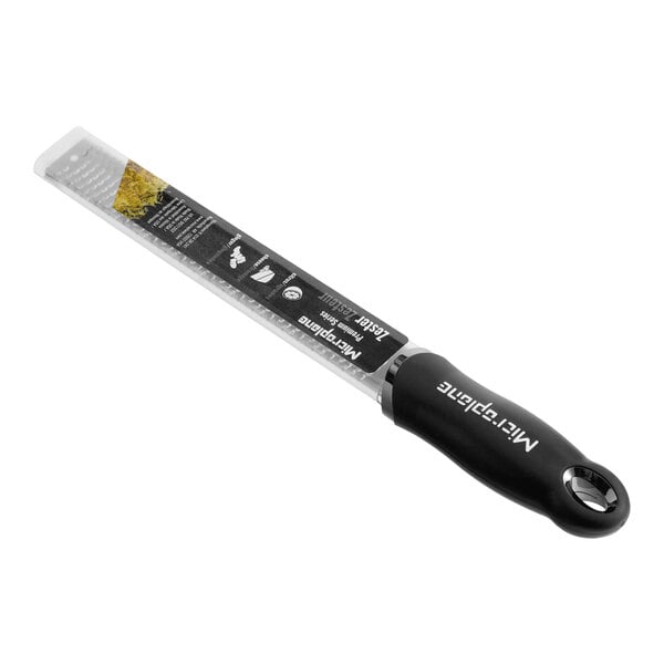 A black-handled Microplane Premium Classic 12-inch zester grater.