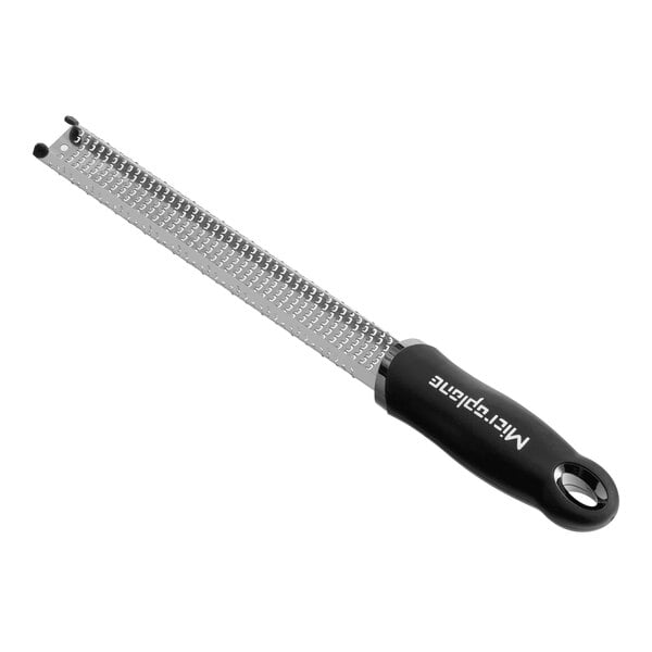 A long, narrow stainless steel zester grater with a black handle.