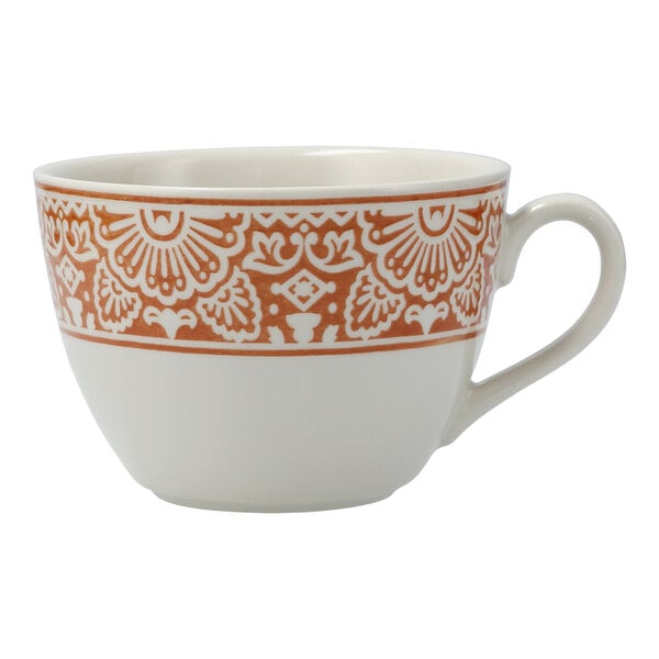 A white Havana by Fortessa tea cup with orange and intricate design.