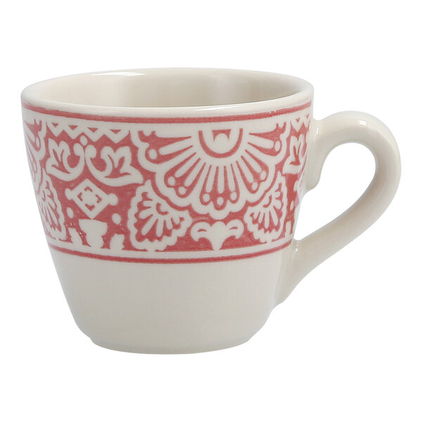 A white espresso cup with a red design on it.