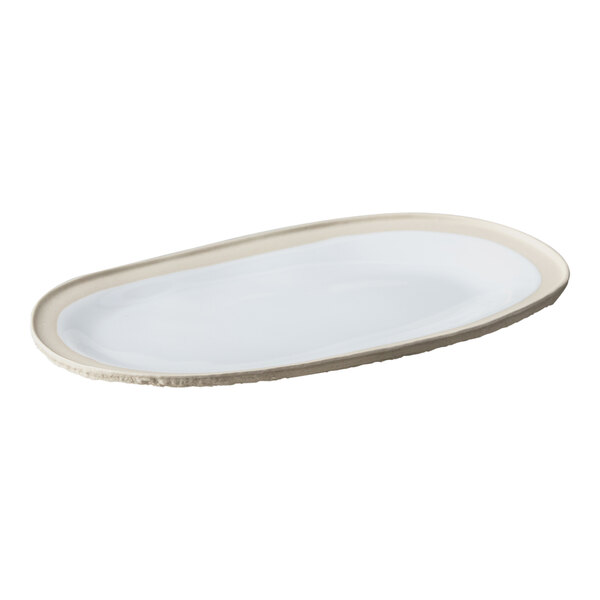 A white oval stoneware platter with a tan rim.