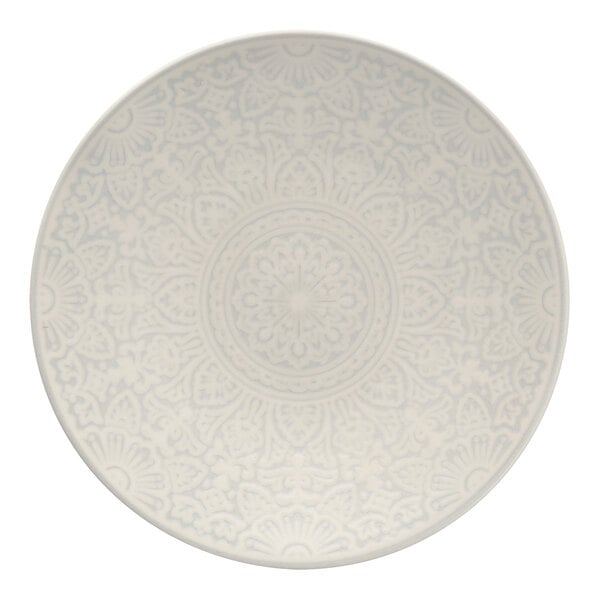 A white Havana by Fortessa coupe plate with a circular pattern on it.