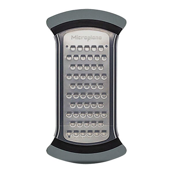 A Microplane grater with a black and grey handle.