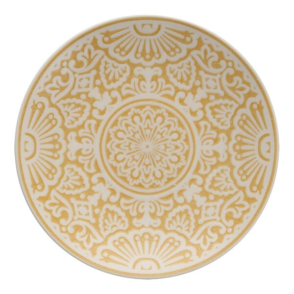 A white coupe plate with a yellow and white intricate design.