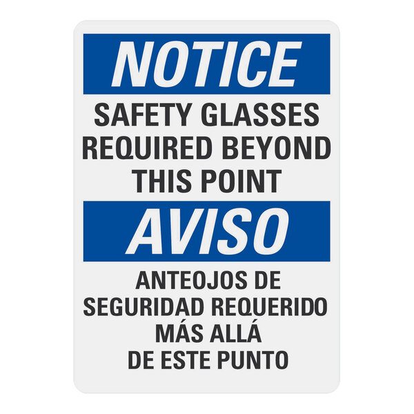 A white rectangular plastic construction sign with blue and white text that reads "Notice Safety Glasses Required Beyond This Point" in English and Spanish.