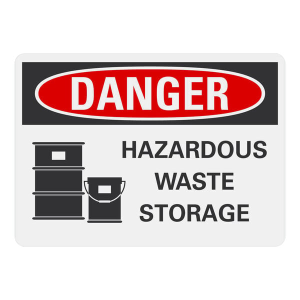 A white plastic sign with black text that reads "Danger / Hazardous Waste Storage" above black barrels.