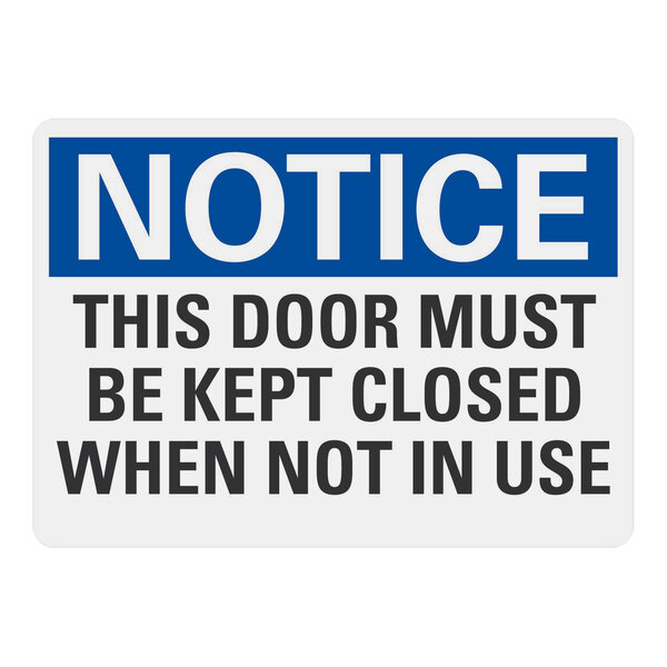 A blue and white rectangular plastic sign with black text that says "Notice / This Door Must Be Kept Closed When Not In Use"