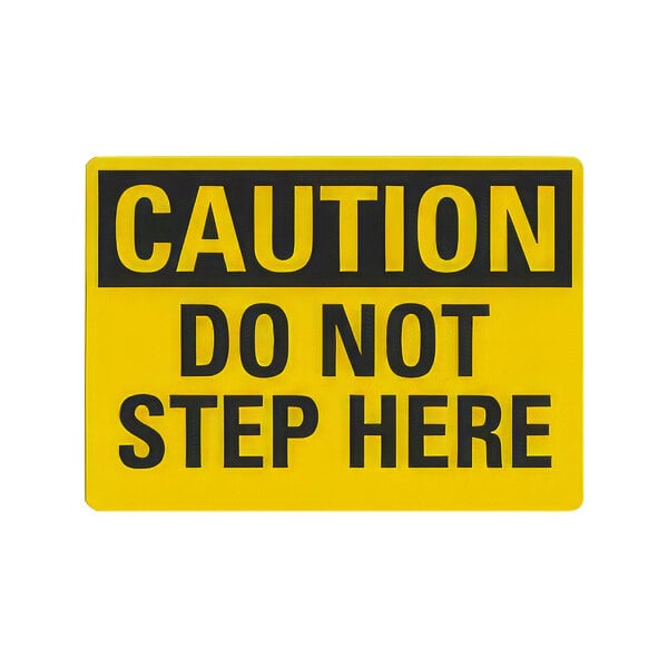 A yellow rectangular sign with black text reading "Caution / Do Not Step Here".