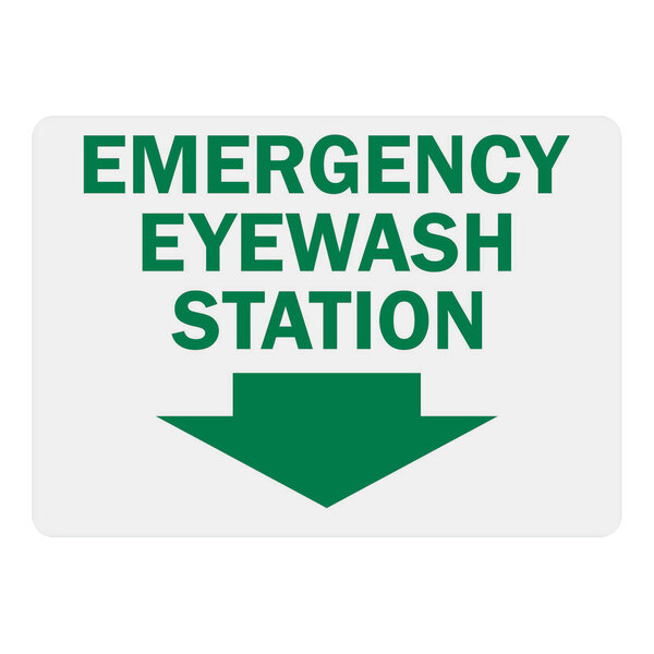 A white sign with green lettering and a green arrow reading "Emergency Eye Wash Station" with green letters and a down arrow.