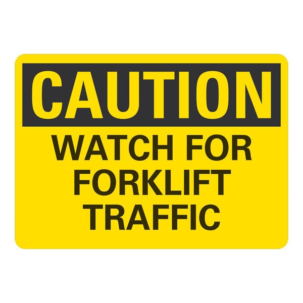A yellow and black rectangular aluminum sign that says "Caution / Watch For Forklift Traffic" in black lettering.