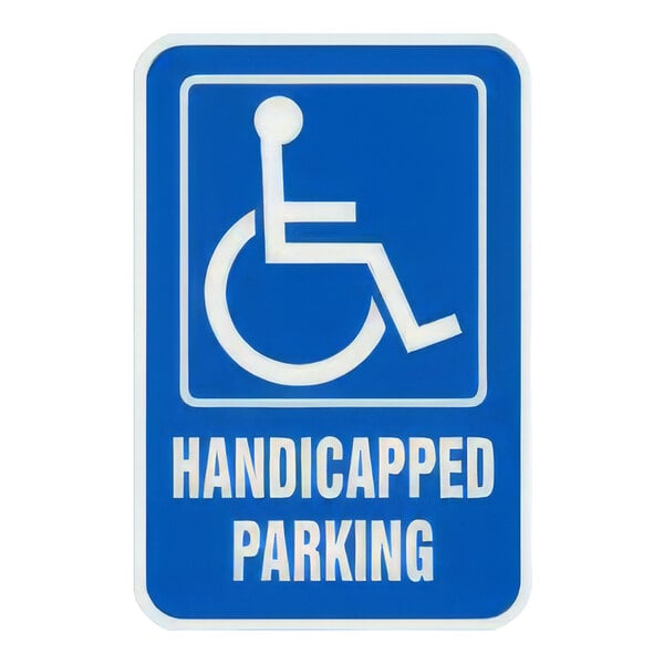 A blue sign with white text that says "Handicapped Parking" and features a white wheelchair symbol.