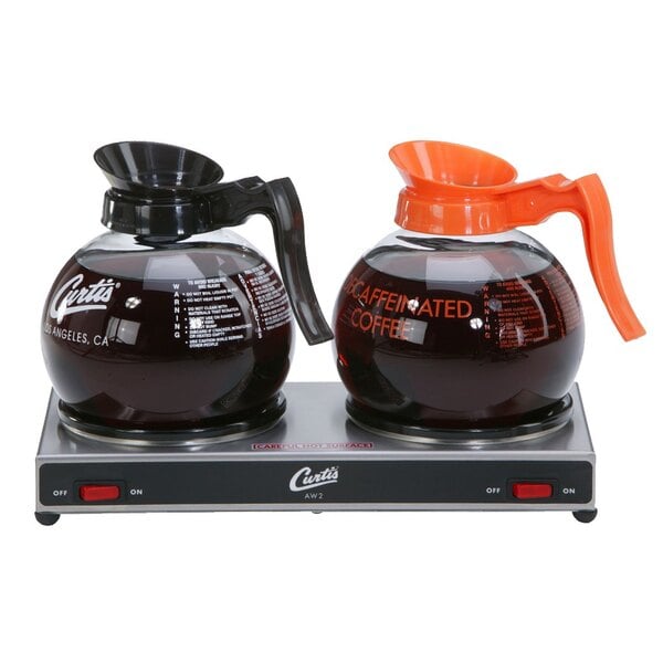 A Curtis coffee pot on a two burner decanter warmer.