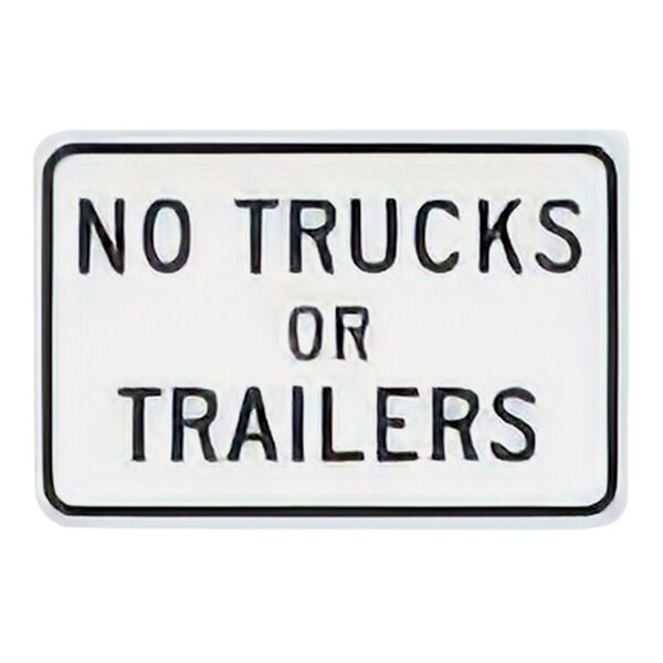 A white rectangular sign with black text reading "No Trucks Or Trailers"