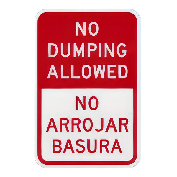 A red and white rectangular sign with white text that says "No Dumping Allowed" in English and Spanish.