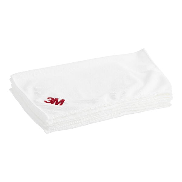 A stack of 3M Scotch-Brite white microfiber cloths.