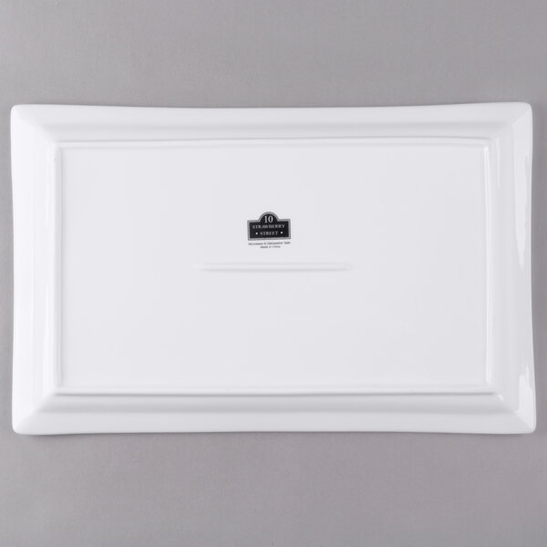 A white rectangular porcelain platter with a black logo.