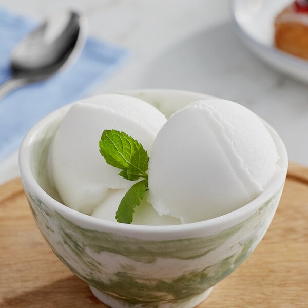 A bowl of Makai Coconut Sorbet with a leaf on top.