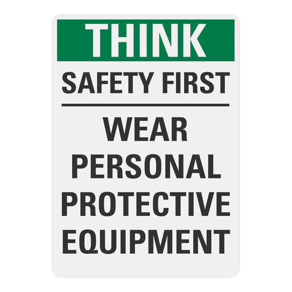 A white sign with black text that says "Think Safety First Wear Personal Protective Equipment" in black.