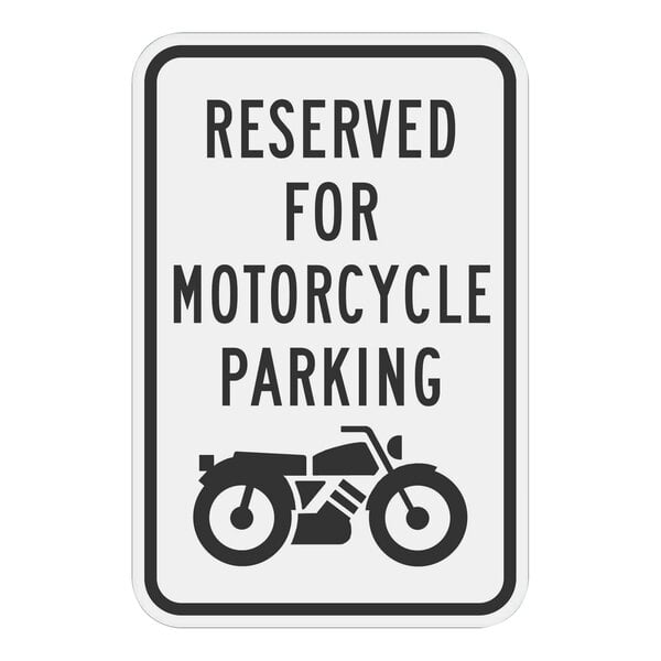 A white rectangular sign with black text and a black and white motorcycle graphic that reads "Reserved For Motorcycle Parking" on it.
