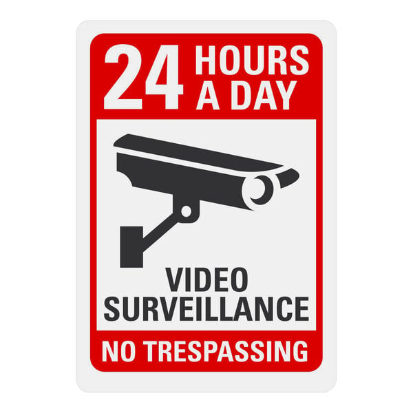 A white and red Lavex adhesive vinyl label with text and a camera symbol reading "24 Hours A Day Video Surveillance No Trespassing"