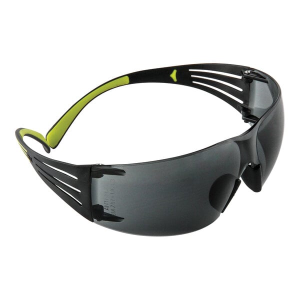 3M SecureFit 400 Series safety glasses with a black and green frame and gray lens.