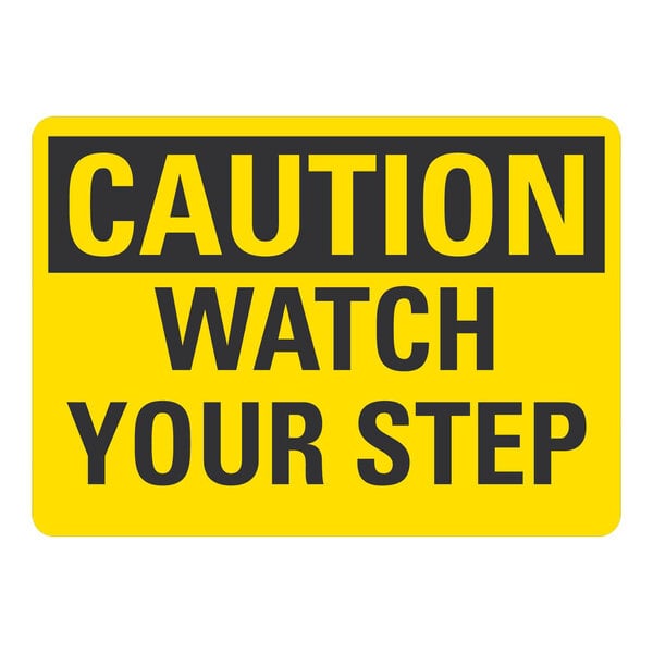 A yellow and black rectangular sign that says "Caution / Watch Your Step" in black text.