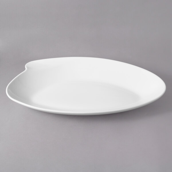 A white porcelain peach bowl with a curved edge.