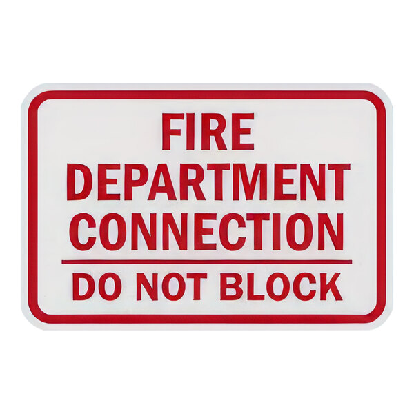 A red letter on a white background sign that says "Fire Department Connection / Do Not Block"