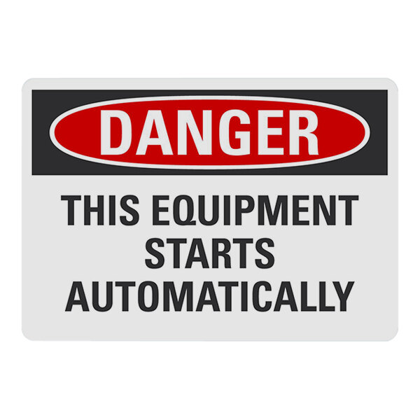 A white rectangular aluminum warehouse sign with black and red text reading "Danger / This Equipment Starts Automatically" and a black border.