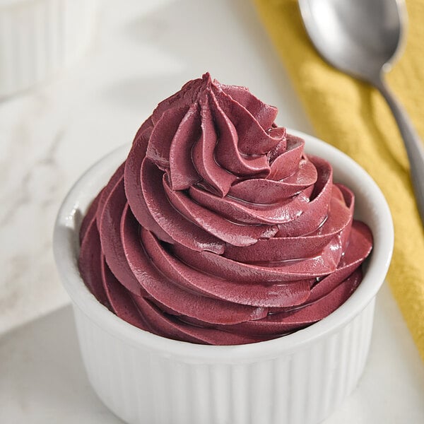 A bowl of red Makai Acai soft serve with a spoon.