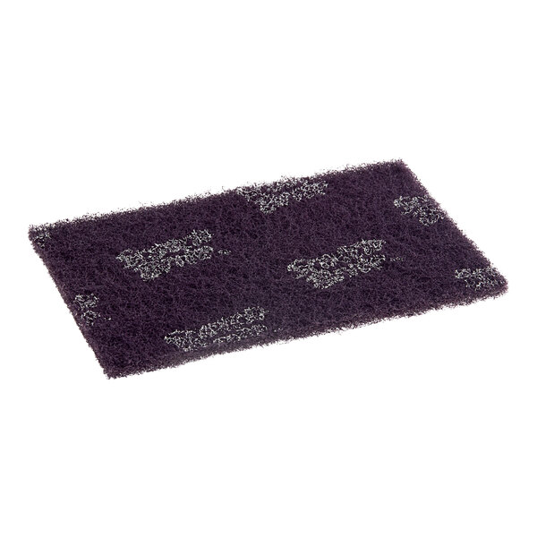 A purple and black 3M Scotch-Brite Extreme Scrub scouring pad with silver dots.