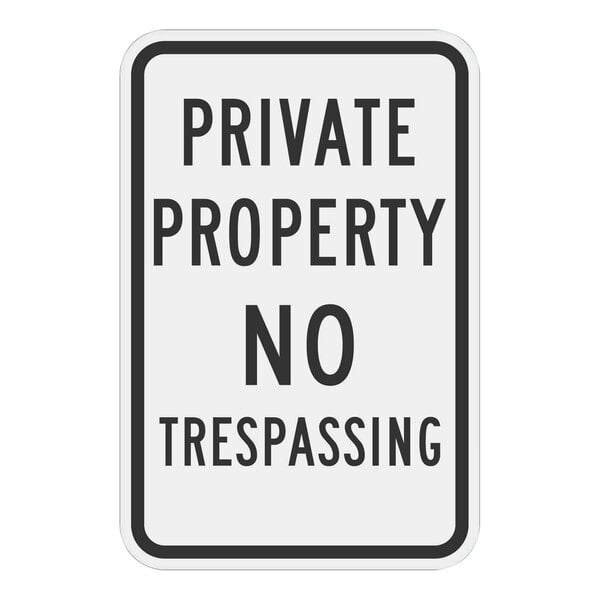 A white reflective aluminum sign with black text that says "Private Property / No Trespassing"