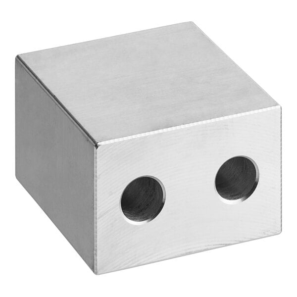 A silver metal cube with two holes in it.