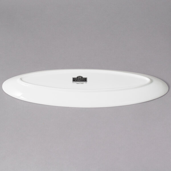 A white oval porcelain platter with leaf edges.