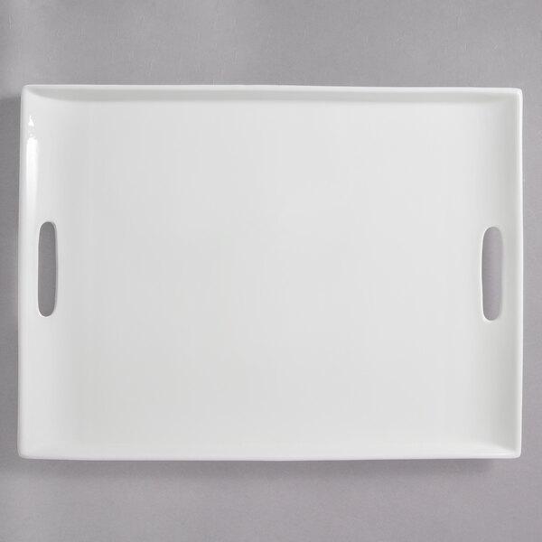A white rectangular porcelain platter with two handles.