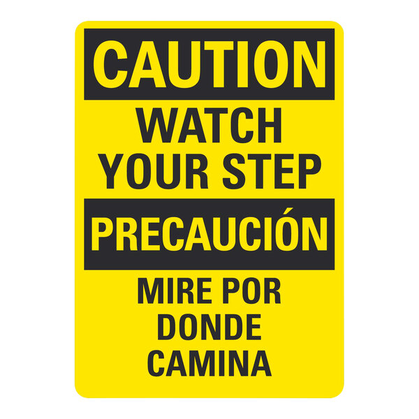 A white rectangular plastic sign with yellow and black text that says "Caution / Watch Your Step" in English and Spanish.