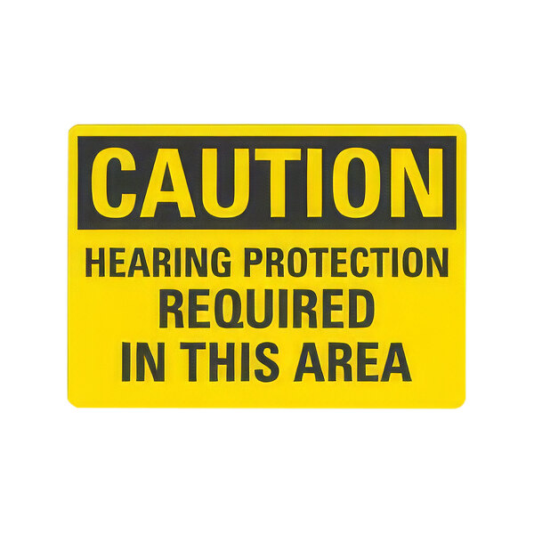 A yellow sign with black text that says "Caution Hearing Protection Required In This Area"