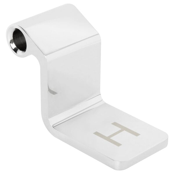 A silver metal T&S hot pedal with the letter H on it.