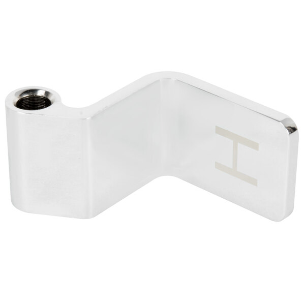 A silver metal T&S Hot Pedal with the letter H on it.