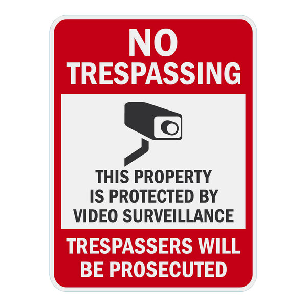 A white aluminum sign with red and black text that says "No Trespassing" and "This Property Is Protected By Video Surveillance" in white.