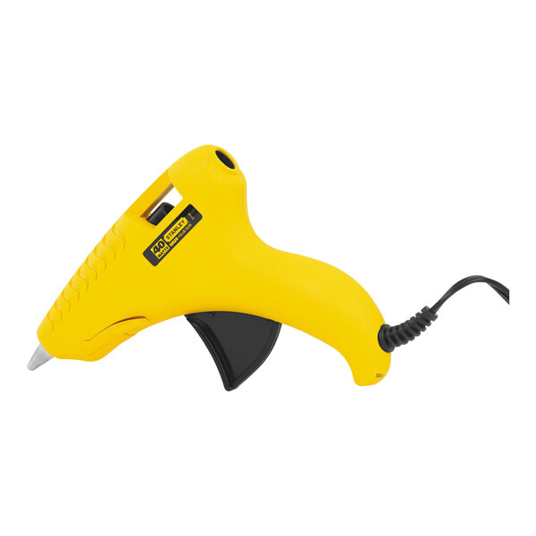 A yellow Stanley GlueShot heavy-duty hot melt glue gun with black cord on a stand.