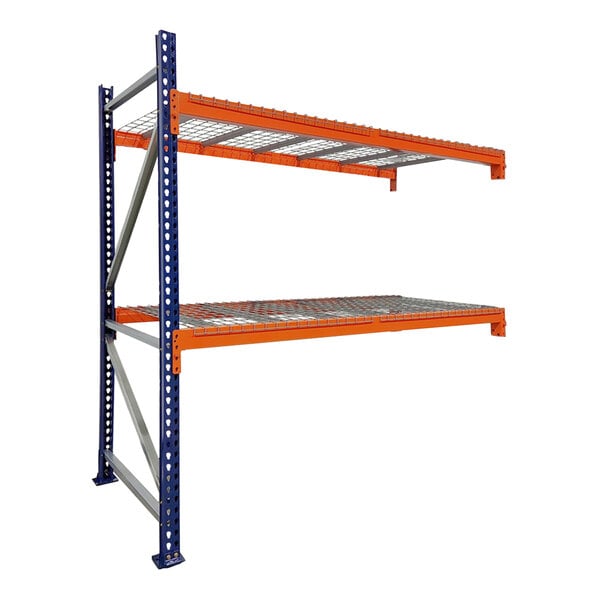 A blue and orange Interlake Mecalux heavy-duty bolted pallet rack add-on with wire deck shelves.