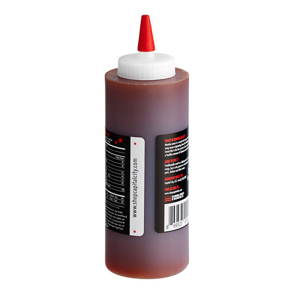 A Capital City Sweet Hot Mambo Sauce bottle with a white cap.
