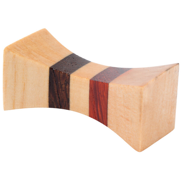 A close-up of a wood block with three red stripes.