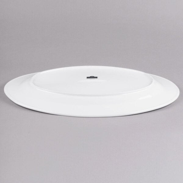 A white oval porcelain platter with a hole in the middle.
